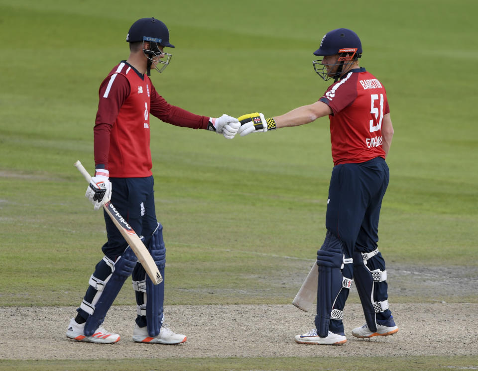 England's Tom Banton, left, fist bumps with batting partner Jonny Bairstow during the second Twenty20 cricket match between England and Pakistan, at Old Trafford in Manchester, England, Sunday, Aug. 30, 2020. (Mike Hewitt/Pool via AP)