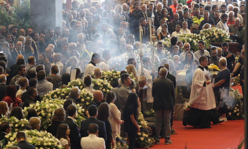 Funerals for some victims took place at an exhibition centre yesterday. 