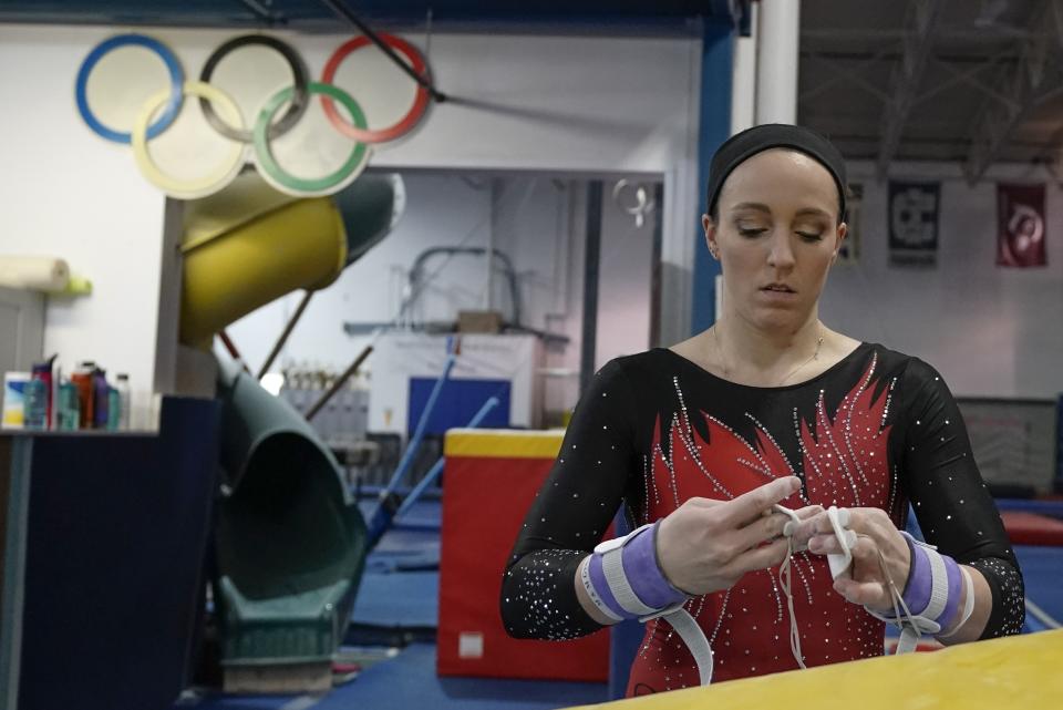 Former gymnastics world champion and Olympic silver medalist Chellsie Memmel works out Thursday, Feb. 18, 2021, in New Berlin, Wisc. The 32-year-old married mother of two is making an unlikely comeback. (AP Photo/Morry Gash)