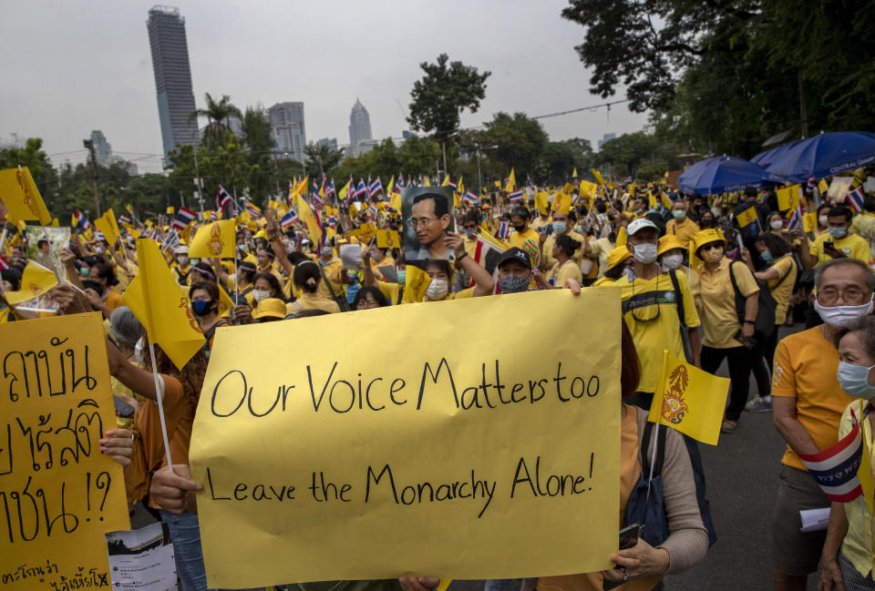 Supporters of the Thai monarchy display placards during a rally at Lumphini park in central Bangkok, Thailand Tuesday, Oct. 27, 2020. Hundreds of royalists gathered to oppose pro-democracy protesters' demands that the prime minister resign, constitution be revised and the monarchy be reformed in accordance with democratic principles. (AP Photo/Gemunu Amarasinghe)