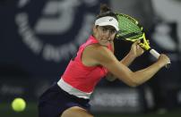 Jennifer Brady of the U.S. returns the ball to Romania's Simona Halep during a semi final match of the Dubai Duty Free Tennis Championship in Dubai, United Arab Emirates, Friday, Feb. 21, 2020. (AP Photo/Kamran Jebreili)