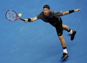 Lleyton Hewitt of Australia reaches for a shot during his men's singles first round match against Zhang Ze of China at the Australian Open 2015 tennis tournament in Melbourne January 20, 2015. REUTERS/Thomas Peter (AUSTRALIA - Tags: SPORT TENNIS)