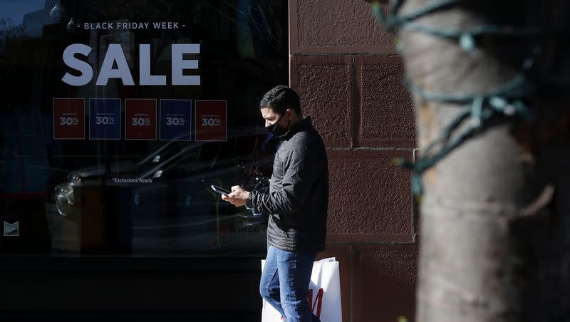 Roberto Gonzalez of Los Angeles walks down Main Street in Salt Lake City on an untraditionally quiet Black Friday, Nov. 27, 2020.