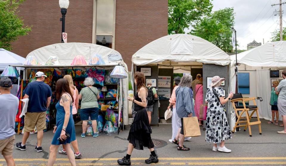 Visitors browse the artist booths on Allen Street at the Central Pennsylvania Festival of the Arts on Thursday, July 11, 2024.