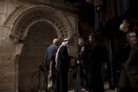 A Palestinian man with a child is questioned by Israeli police in the Old City of Jerusalem on his way to prayers at the Al Aqsa Mosque compound marking Moulid al-Nabi, the birthday of the Prophet Muhammad, Tuesday, Oct. 19, 2021. (AP Photo/Maya Alleruzzo)