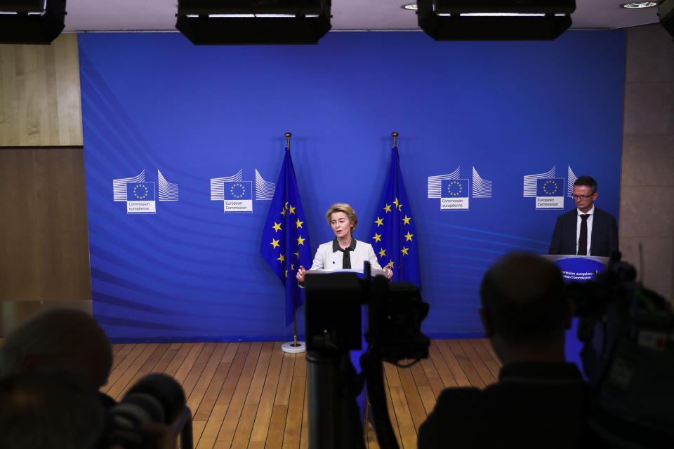 European Commission President Ursula von der Leyen, center, gives a press statement on the European Green Deal at the European Commission headquarters in Brussels, Wednesday, Dec. 11, 2019. In her bid to lead the EU toward climate neutrality, European Commission president Ursula von der Leyen wants to put up 100 billion euros (dollars 130 billion U.S.) to help member countries that still heavily rely on fossil fuels transition to lower emissions. (AP Photo/Francisco Seco)