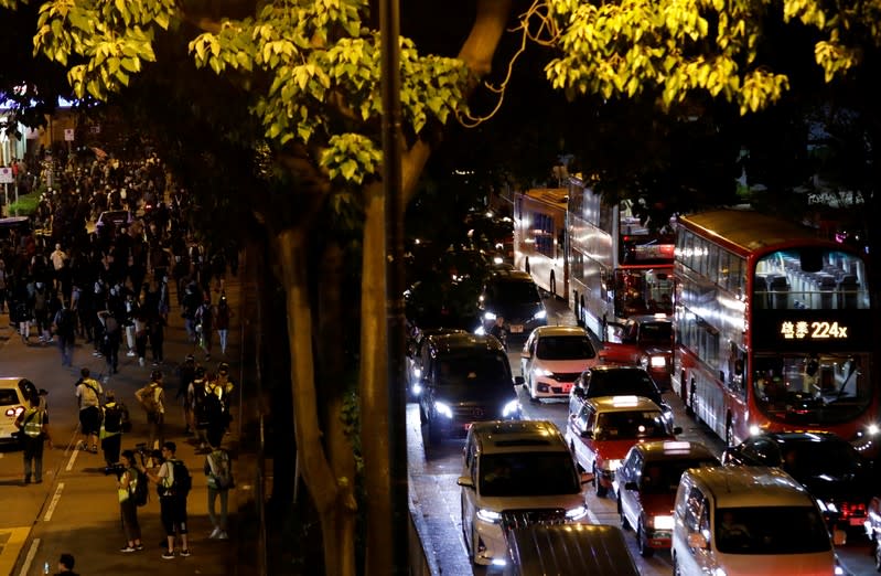 Cars stand in a traffic jam as anti-government protesters block the road in Hong Kong