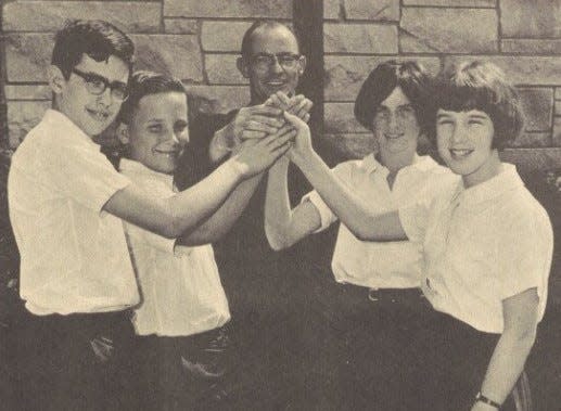 In this photo from 1967, Mike Ingram (second from left) and three other pupils at St. Mary on the Hill School helps the Rev. Cyril Gabbett demonstrate how to dance a four-hand Irish reel. Ingram, who went on to become a priest himself, died April 2 at age 69.