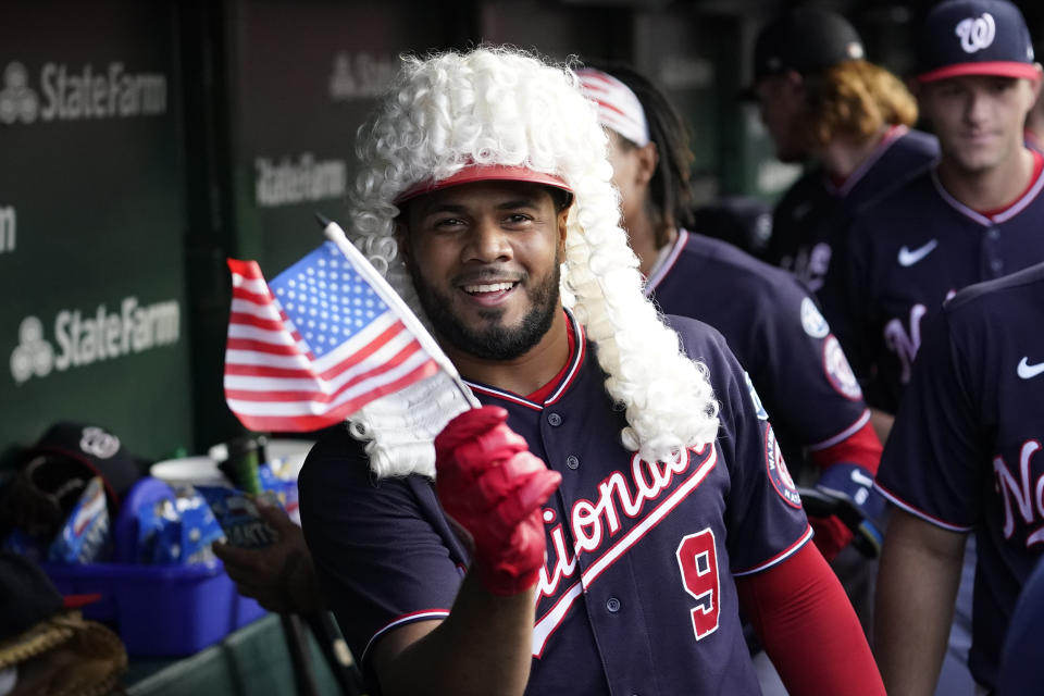 Washington Nationals' Jeimer Candelario wears the home run wig as he celebrates his two-run home run off Chicago Cubs starting pitcher Drew Smyly during the first inning of a baseball game Monday, July 17, 2023, in Chicago. (AP Photo/Charles Rex Arbogast)