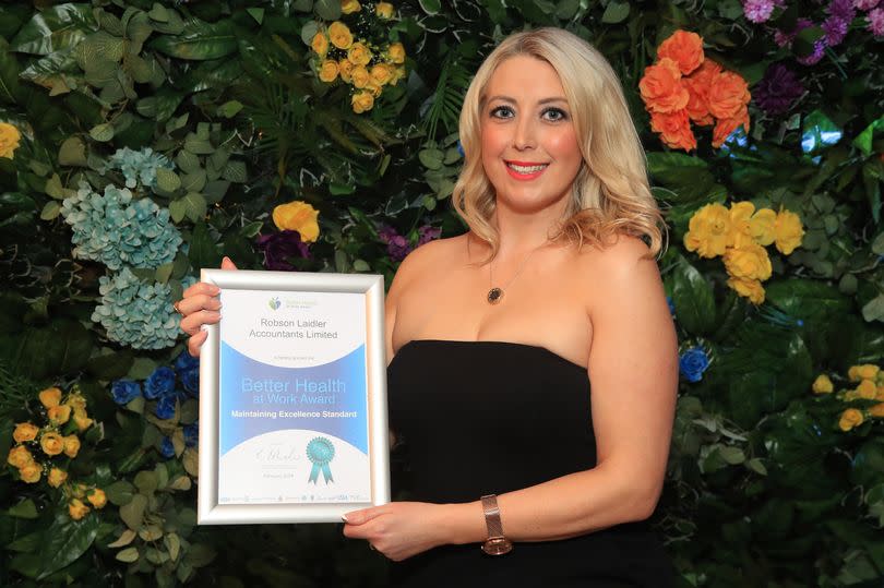 Robson Laidler’s workplace health ambassador Gemma Graham receiving the Better Health At Work Award on behalf of the firm.