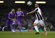 <p>Gonzalo Higuain of Juventus in action during the UEFA Champions League Final between Juventus and Real Madrid at National Stadium of Wales </p>