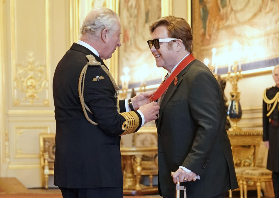 Sir Elton John is made a member of the Order of the Companions of Honour by Prince Charles during an investiture ceremony at Windsor Castle, in Windsor, England, Wednesday, Nov. 10, 2021. (Aaron Chown/PA via AP)