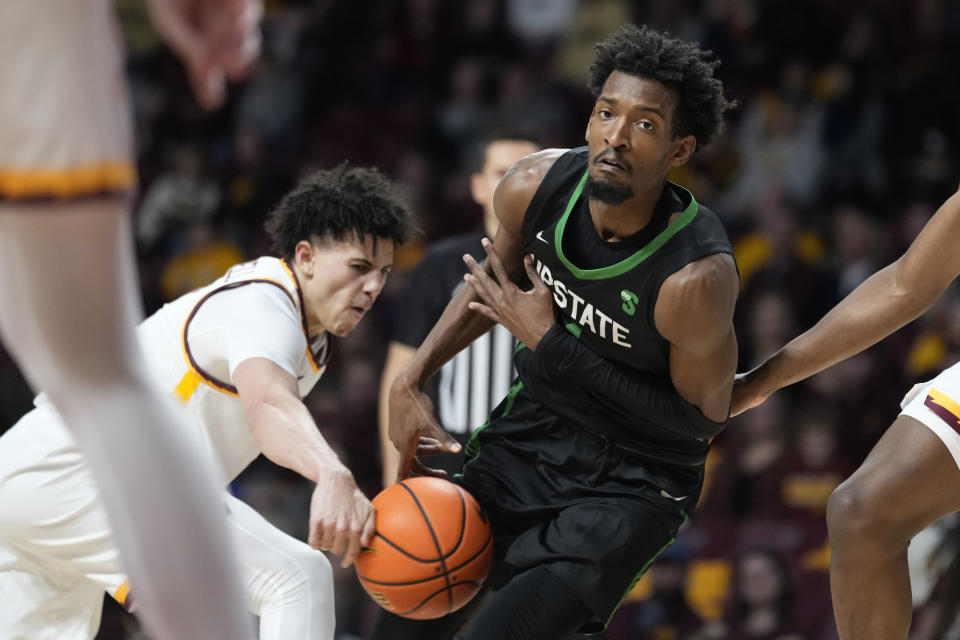 Minnesota guard Braeden Carrington, left, strips the basketball from USC Upstate guard Nick Alves during the second half of an NCAA college basketball game, Saturday, Nov. 18, 2023, in Minneapolis. (AP Photo/Abbie Parr)