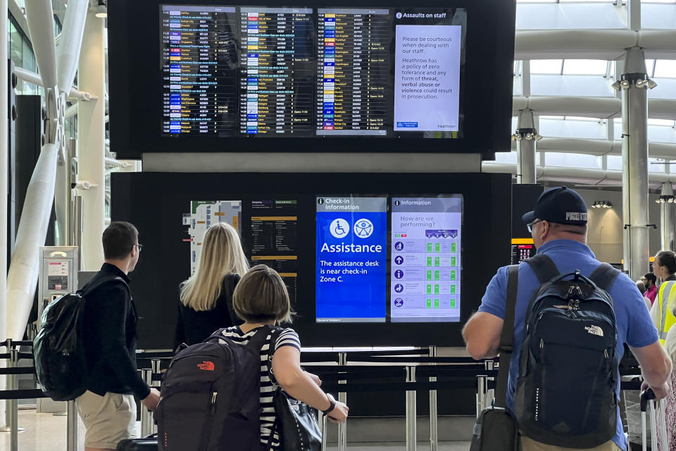 Travellers at Heathrow airport, in London, Wednesday, July 13, 2022. Heathrow Airport has introduced a cap on passenger numbers this summer as the aviation sector struggles to cope with demand for travel. No more than 100,000 daily passengers will be able to depart from July 12 until Sept. 11, the west London airport announced. (AP Photo/Alberto Pezzali)