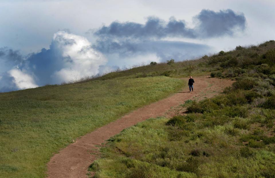 Peter Simons of Newbury Park goes down a hiking trail on his daily exercise at Rancho Sierra Vista-Satwiwa in Newbury Park in February 2023.