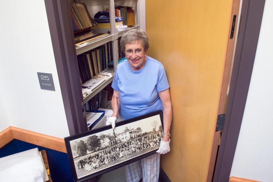 This file photo from 2016 shows Joan Bowen holding an old class photo from the Chambersburg Area School District archives. This is shortly before the archives were moved from a storage closet at the CASD Administration Building to a two-room space in the District Annex, 721 S. Sixth St.