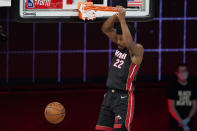Miami Heat's Jimmy Butler (22) dunks in the second half of an NBA conference semifinal playoff basketball game against the Milwaukee Bucks Friday, Sept. 4, 2020, in Lake Buena Vista, Fla. (AP Photo/Mark J. Terrill)