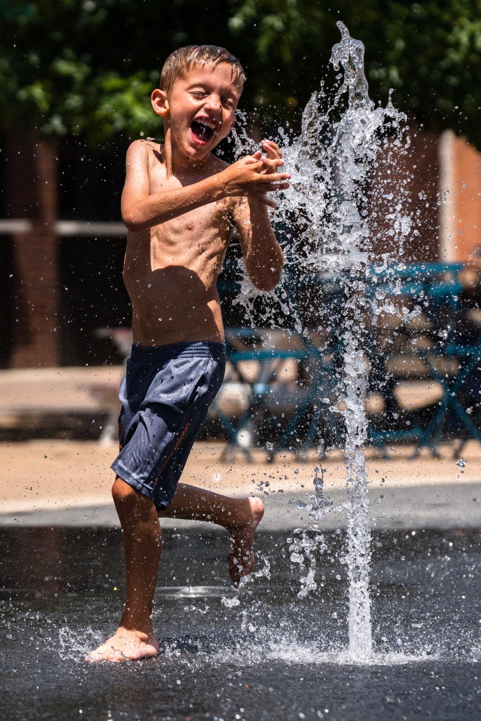 Kade McArdle, 5, plays in a splash pad on a hot day in downtown Fort Collins on July 17, 2023.