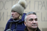 Serbia's Novak Djokovic's father Srdjan, right, and mother Dijana attend a protest in Belgrade, Serbia, Saturday, Jan. 8, 2022. The No. 1-ranked Djokovic was denied entry at the Melbourne airport late Wednesday after border officials canceled his visa for failing to meet its entry requirement that all non-citizens be fully vaccinated for COVID-19. (AP Photo/Darko Vojinovic)