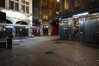 The empty center of Lyon, central France, is seen after the start of the curfew, Saturday, Oct. 17, 2020. France is deploying 12,000 police officers to enforce a new curfew that came into effect Friday night for the next month to slow the virus spread, and will spend another 1 billion euros to help businesses hit by the new restrictions. (AP Photo/Laurent Cipriani)