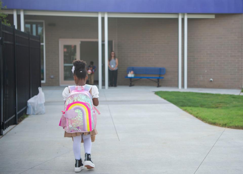 A student walks into the school on the first day of school on Aug. 8, 2023, at Goodlettsville Elementary School in Goodlettsville, Tenn.