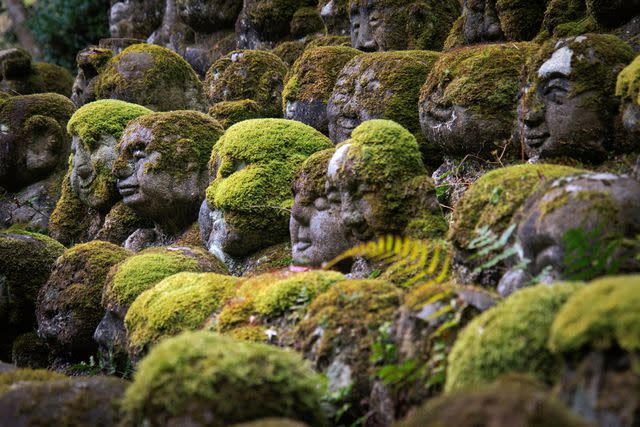 <p>AwOiSoAk/Getty Images</p> Rakan sculptures in Arashiyama, Kyoto.