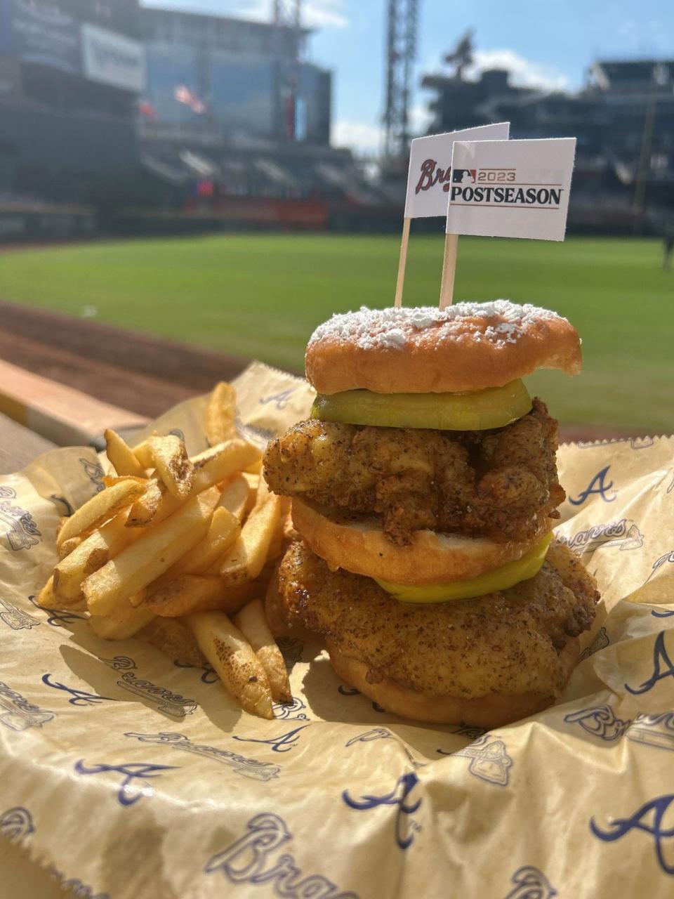 “Chicken ain’t nothing but a bird Blue”: Double stack fried wet lemon pepper free-range chicken breast sandwiched between 3 glazed donuts and Southern angry pickled green tomatoes finished with peach bourbon coulis and powdered sugar. Available at 1871 Grille near sections 215 and 239.
