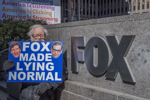 A protester holding a sign that reads 