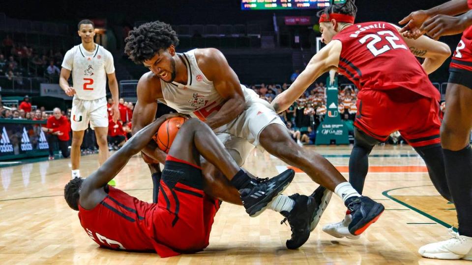 Miami Hurricanes forward Norchad Omier (15) and Rutgers Scarlet Knights forward Mawot Mag (3) battle for the ball in the second half at the Watsco Center in Coral Gables on Wednesday, November 30, 2022.