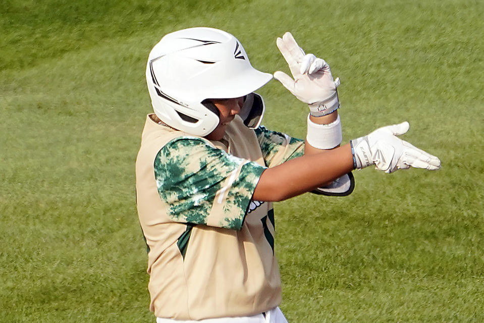 Taiwan's Hsu Shao-Chieh celebrates while standing on second base after driving in two runs off Japan's Akito Masuda during the first inning of a baseball game at the Little League World Series tournament in South Williamsport, Pa., Monday, Aug. 21, 2023. (AP Photo/Tom E. Puskar)