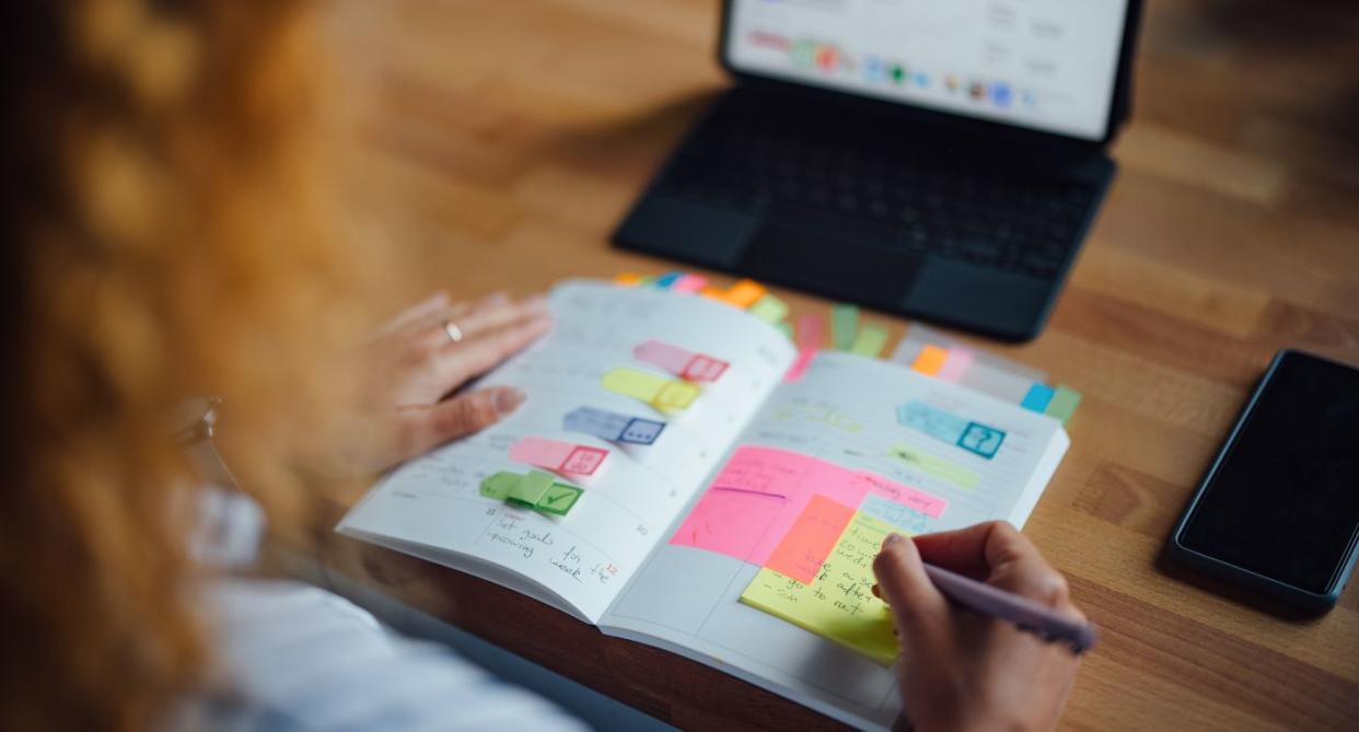 Life hacks woman planning day in diary. (Getty Images)