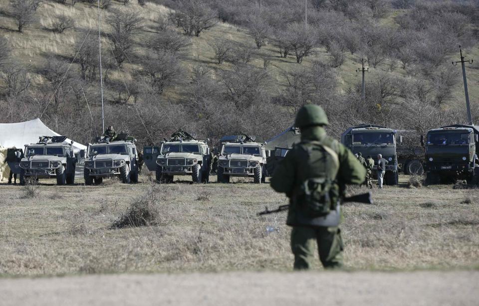 Military vehicles, believed to be property of Russian army, are seen near the territory of a Ukrainian military unit in the village of Perevalnoye outside Simferopol