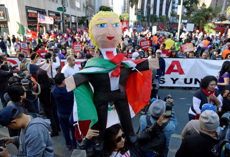 Protester holds up pinata representing President-elect Donald Trump during a march and rally against President-elect Trump in Los Angeles, California, U.S. December 18, 2016. REUTERS/Kevork Djansezian