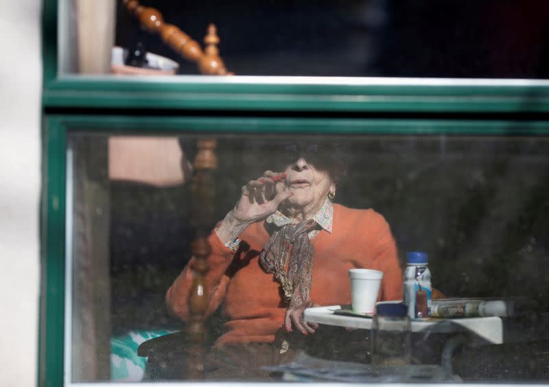 FILE PHOTO: A resident waves from her room inside a seniors' long-term care facility in Montreal