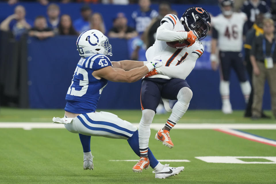 Chicago Bears' DeAndre Carter (11) is tackled by Indianapolis Colts safety Trevor Denbow (43) on a punt return during the first half of an NFL football game Sunday, Sept. 22, 2024, in Indianapolis. (AP Photo/Darron Cummings)