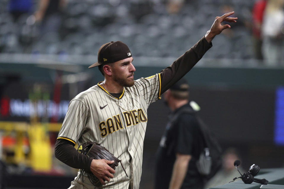 San Diego Padres starting pitcher Joe Musgrove gestures to fans after pitching a no-hitter against the Texas Rangers in a baseball game Friday, April 9, 2021, in Arlington, Texas. (AP Photo/Richard W. Rodriguez)