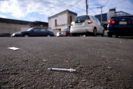 FILE PHOTO: A needle used for shooting heroin and other opioids lies in the street in the Kensington section of Philadelphia, Pennsylvania, U.S., October 26, 2017. REUTERS/Charles Mostoller/File Photo