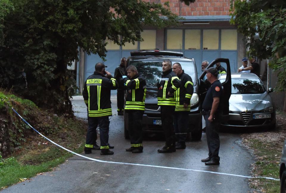 Emergency service personnel stand by near the scene of the shooting (AFP via Getty Images)