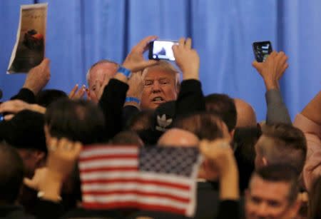 Donald Trump greets supporters after speaking after being declared by the television networks as the winner of the Nevada Republican caucuses at his caucus night rally in Las Vegas. REUTERS/Jim Young