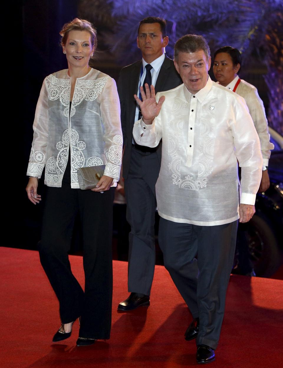 Colombia's President Santos, wearing the traditional Philippine "barong", and his wife Rodriguez Munera for a welcome dinner during the Asia-Pacific Economic Cooperation (APEC) summit in the capital city of Manila, Philippines
