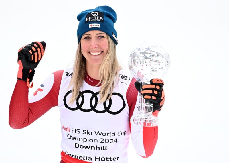 Austria's Cornelia Huetter celebrates with the trophy after the Women's Downhill during the FIS Ski Alpine World Cup. Barbara Gindl/APA/dpa