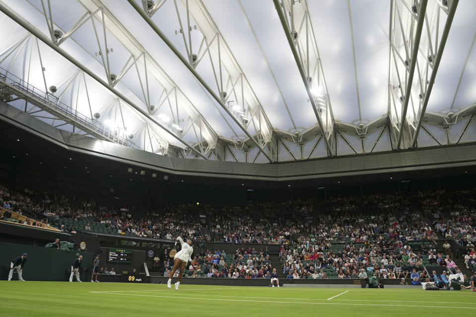 Serena Williams of the US serves to France's Harmony Tan in a first round women's singles match on day two of the Wimbledon tennis championships in London, Tuesday, June 28, 2022. (AP Photo/Alberto Pezzali)