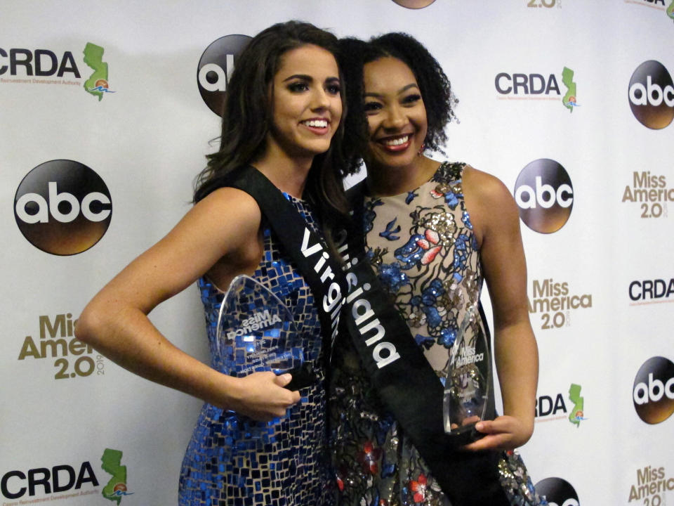 Miss Virginia Emili McPhail, left, won the onstage interview portion and Miss Louisiana Holli' Conway, right, won the talent portion of the second night of preliminary competition in the Miss America pageant in Atlantic City N.J. on Thursday Sept. 6, 2018. (AP Photo/Wayne Parry)