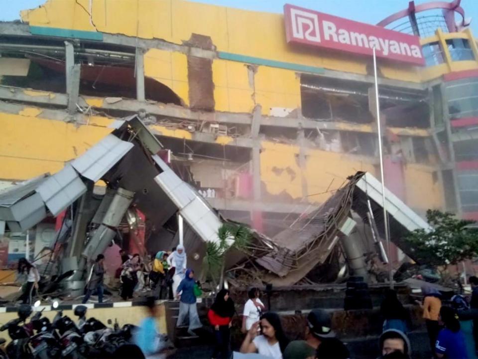 The wave caused buildings to collapse (Reuters)