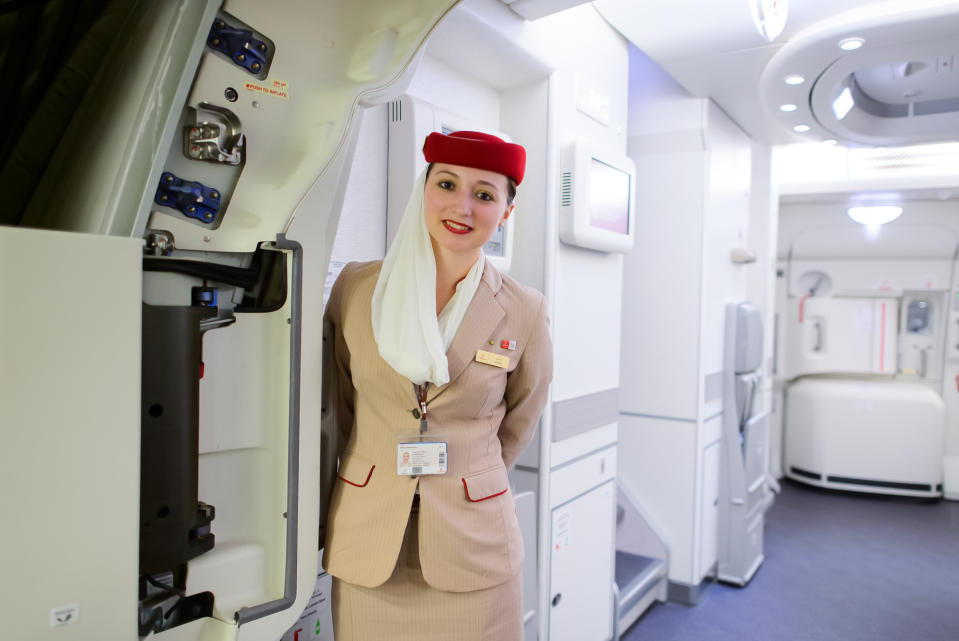 Dubai, United Arab Emirates - March 10, 2015: Emirates Airbus A380 crew member. Emirates handles major part of passenger traffic and aircraft movements at the airport.