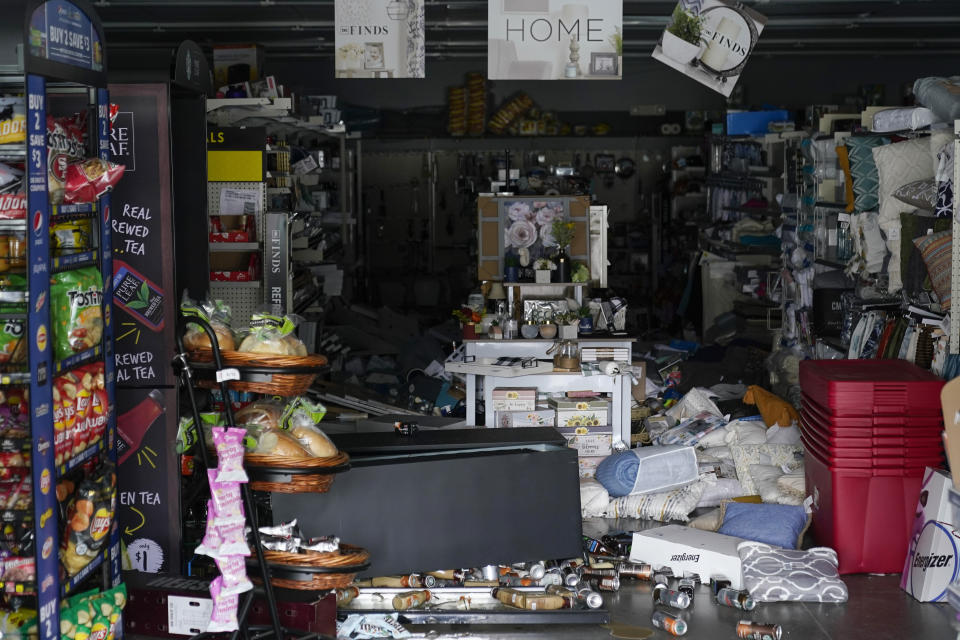 Merchandise can be seen knocked off the shelves inside a Dollar General store after an earthquake in Rio Dell, Calif., Tuesday, Dec. 20, 2022. A strong earthquake shook a rural stretch of Northern California early Tuesday, jolting residents awake, cutting off power to 70,000 people, and damaging some buildings and a roadway, officials said. (AP Photo/Godofredo A. Vásquez)