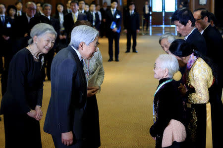 Nguyen Thi Xuan (R), 92, married to former Japanese soldier, greets Japanese Emperor Akihito (L) and Empress Michiko (2-L) as they meet with family members of Japanese veterans living in Vietnam, at a hotel in Hanoi, Vietnam, March 2, 2017. REUTERS/Minh Hoang/Pool