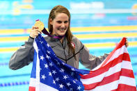 LONDON, ENGLAND - JULY 30: Missy Franklin of the United States celebrates with her gold medal and an American flag during the medal ceremony for the Women's 100m Backstroke on Day 3 of the London 2012 Olympic Games at the Aquatics Centre on July 30, 2012 in London, England. (Photo by Al Bello/Getty Images)