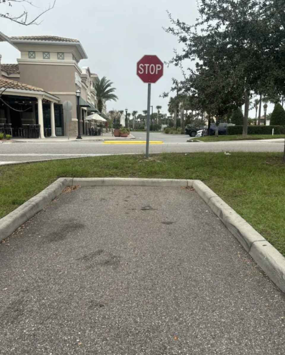 a stop sign in front of a parking space