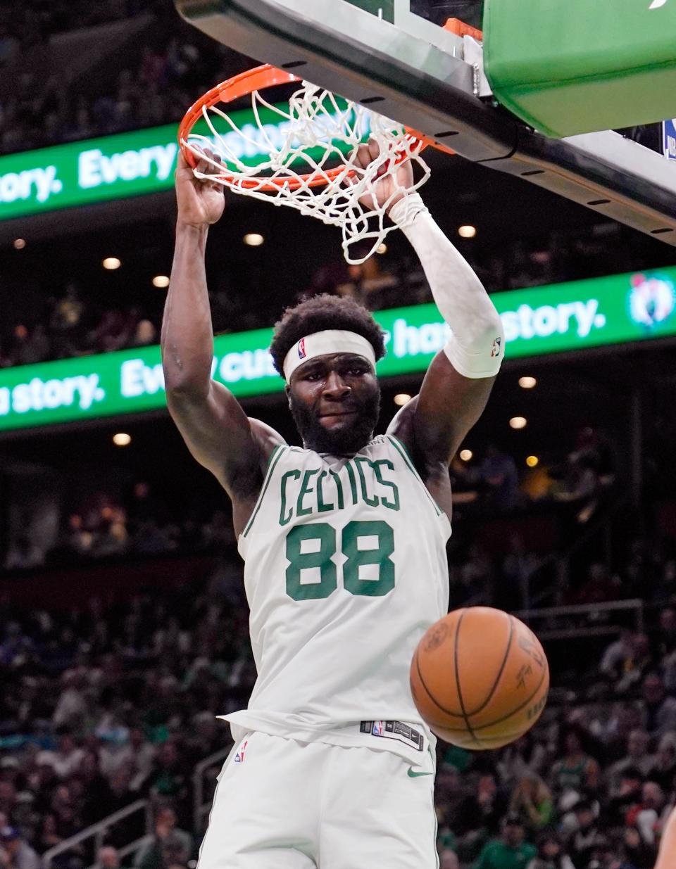 Boston Celtics center Neemias Queta (88) slams a dunk during the second half of an NBA basketball game against the Detroit Pistons, Thursday, Dec. 28, 2023, in Boston. (AP Photo/Charles Krupa)